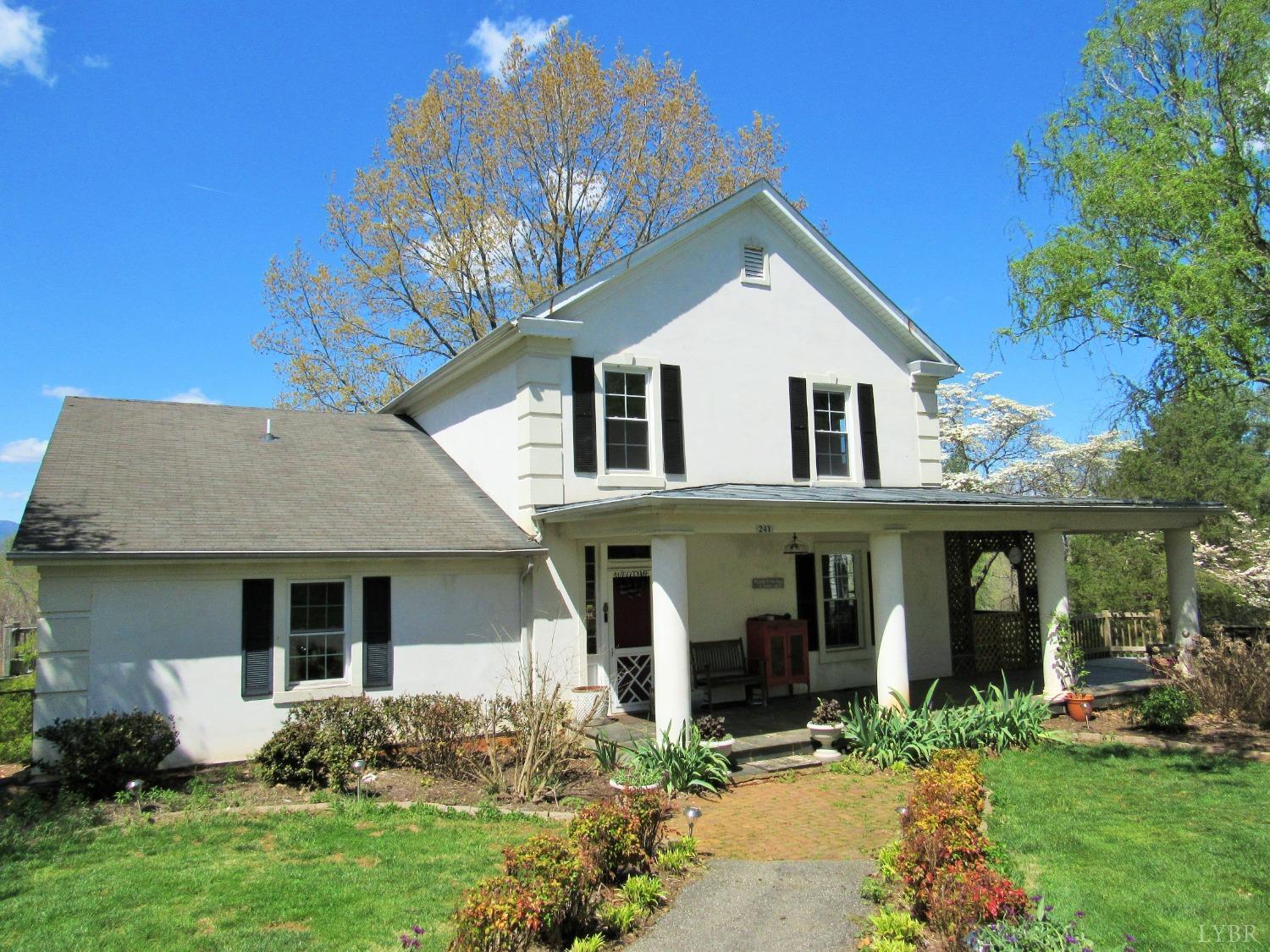 241 Hanger Road Amherst, VA 24521 - Photo 2 of 51 a front view of a house with a yard and porch
