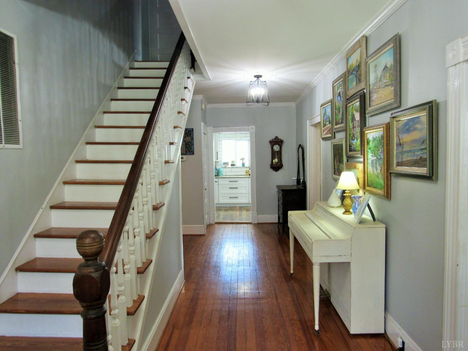241 Hanger Road Amherst, VA 24521 - Photo 5 of 51 a hallway with wooden floor stairs and furniture