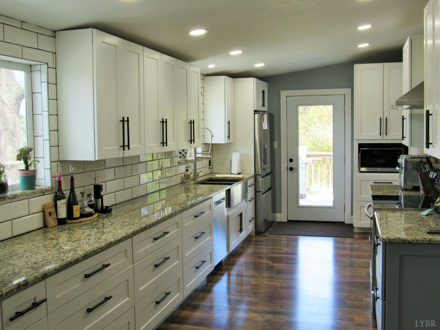 241 Hanger Road Amherst, VA 24521 - Photo 9 of 51 a large kitchen with kitchen island granite countertop a large window and stainless steel appliances