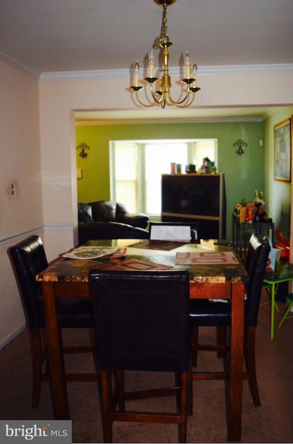 8841 Ritchboro Road District Heights, MD 20747 - Photo 3 of 4 a view of a dining room with furniture and chandelier