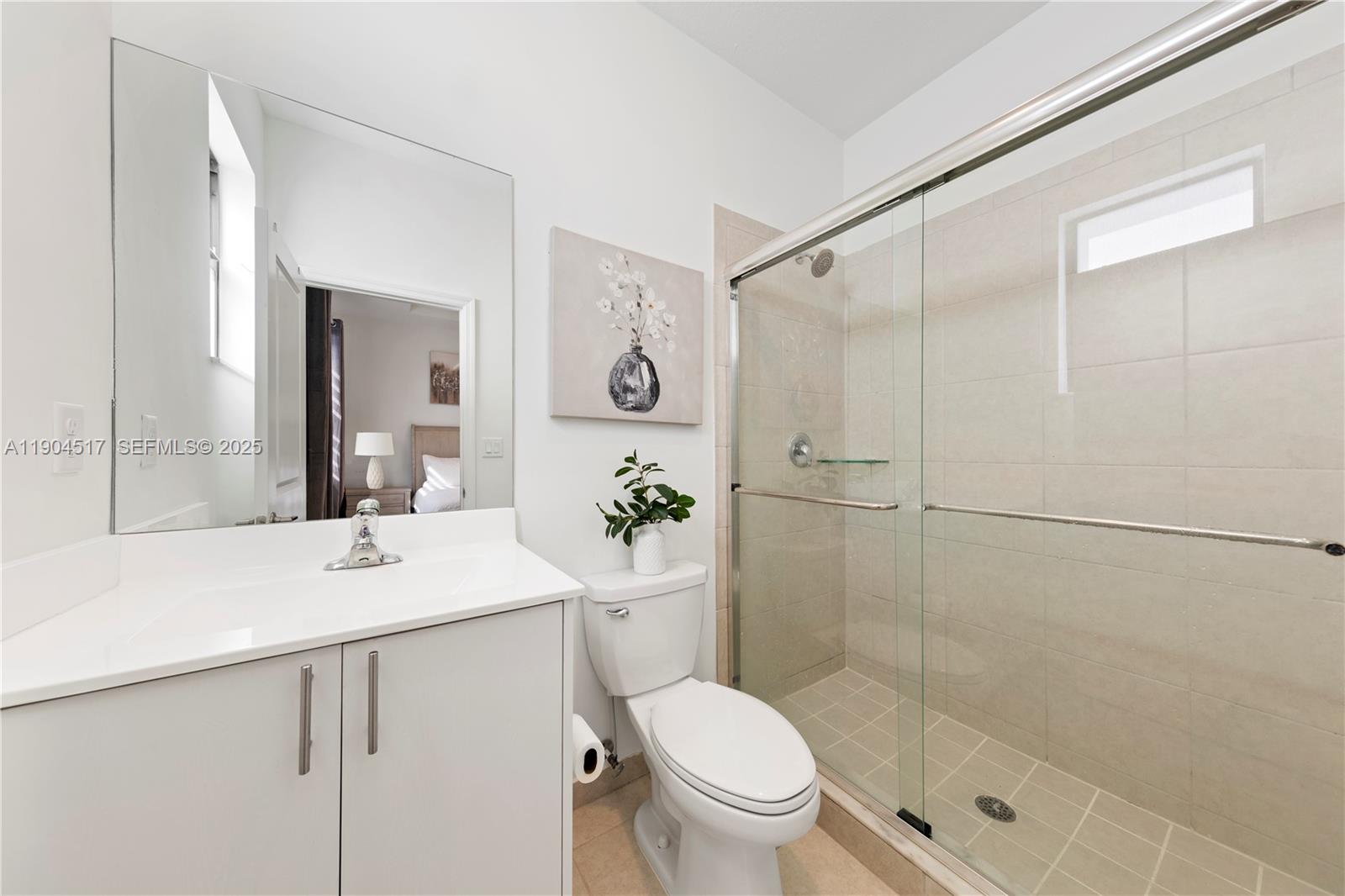 12942 Southwest 232nd Terrace Homestead, FL 33032 - Photo 13 of 27 a bathroom with a shower sink vanity mirror and toilet