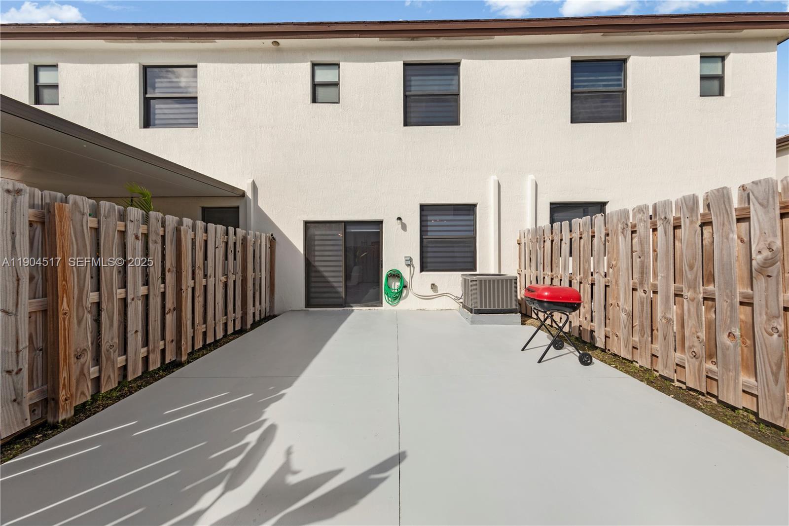 12942 Southwest 232nd Terrace Homestead, FL 33032 - Photo 17 of 27 a view of a terrace with wooden fence