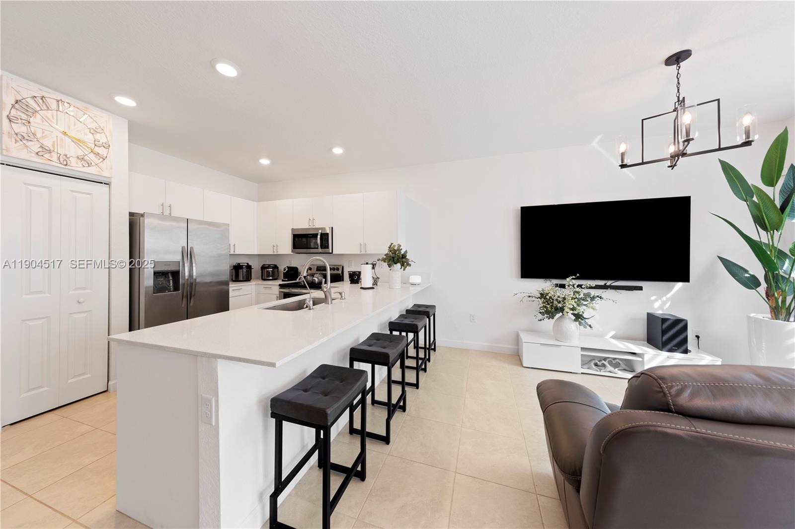 12942 Southwest 232nd Terrace Homestead, FL 33032 - Photo 2 of 27 a living room with furniture and a flat screen tv