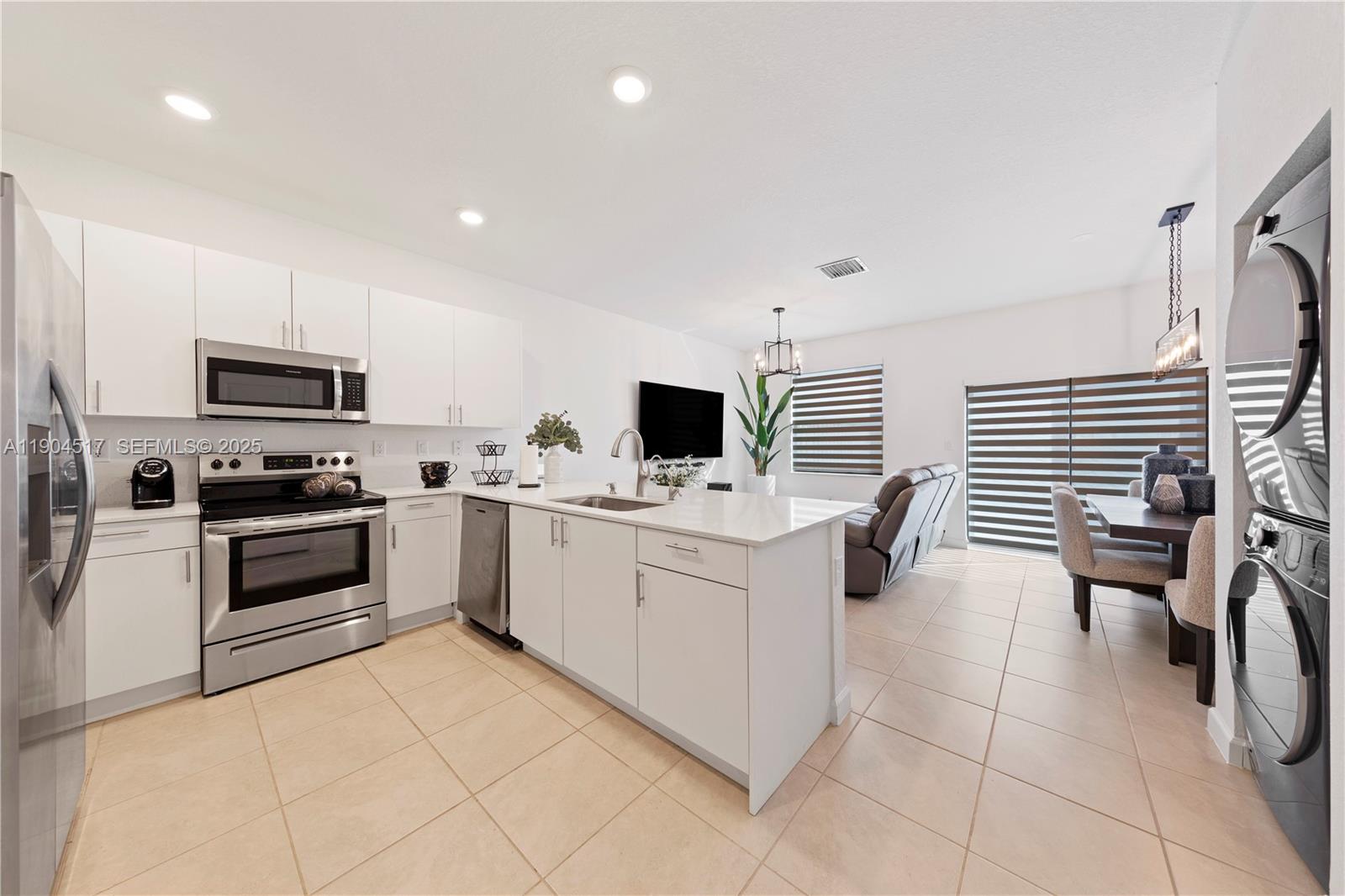 12942 Southwest 232nd Terrace Homestead, FL 33032 - Photo 3 of 27 a kitchen with stainless steel appliances a stove top oven a sink a counter top space and cabinets