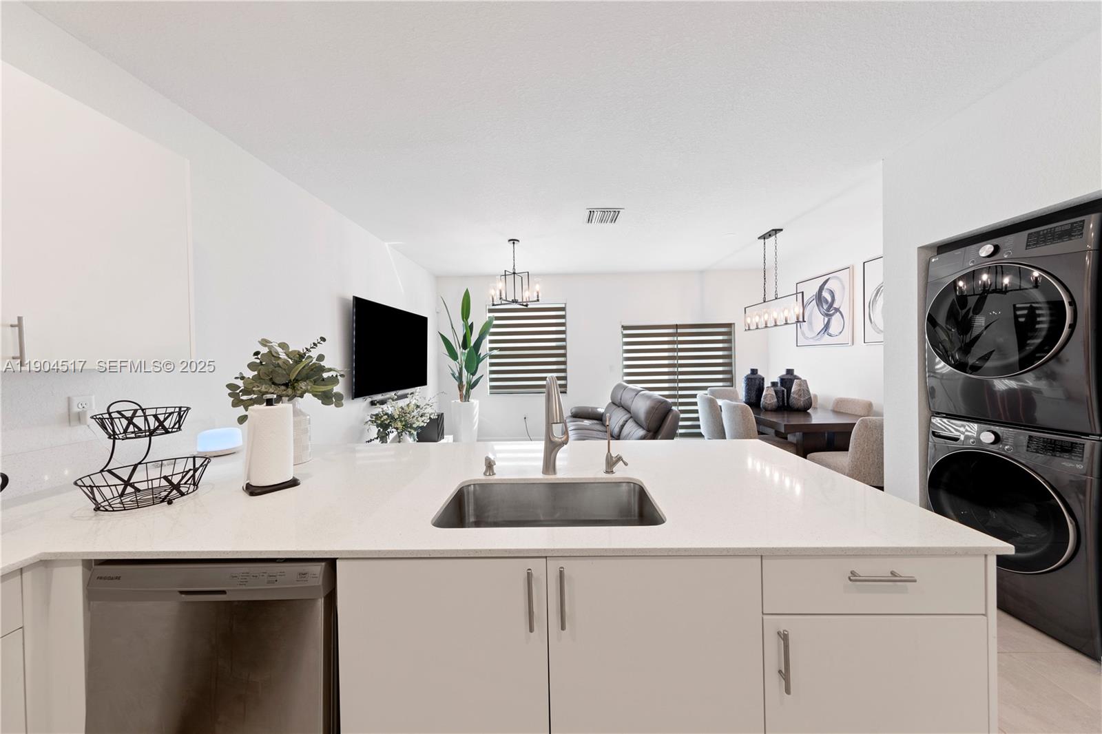 12942 Southwest 232nd Terrace Homestead, FL 33032 - Photo 7 of 27 a kitchen with a sink a washer and dryer