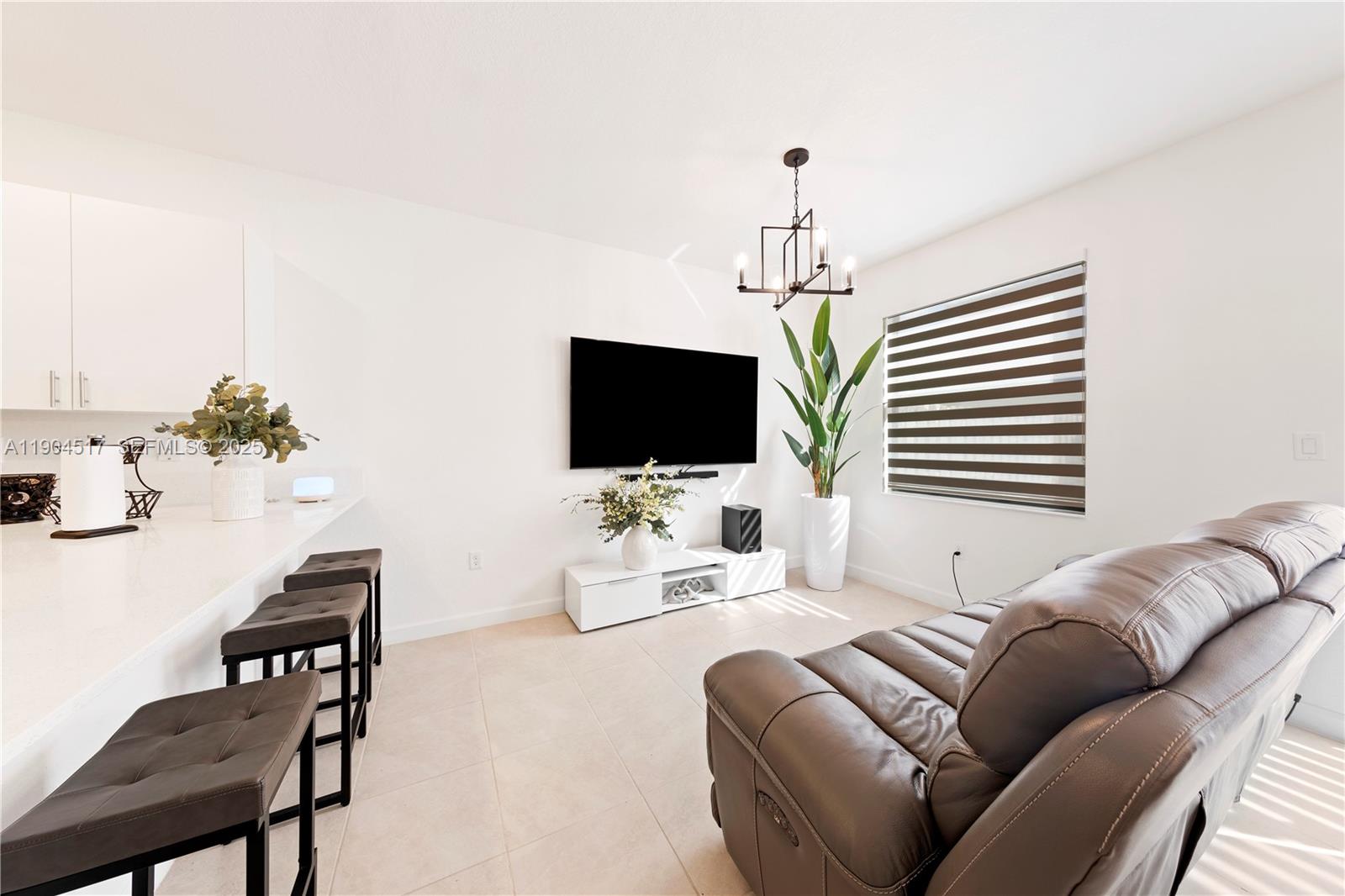 12942 Southwest 232nd Terrace Homestead, FL 33032 - Photo 9 of 27 a living room with furniture and a flat screen tv
