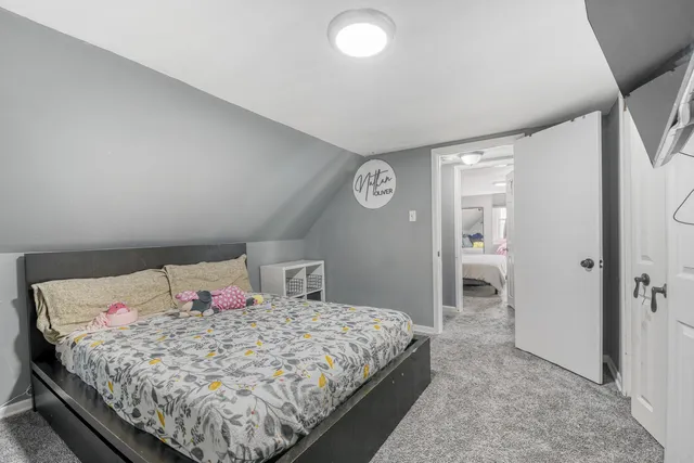 a bedroom with a bed and a view of bathroom