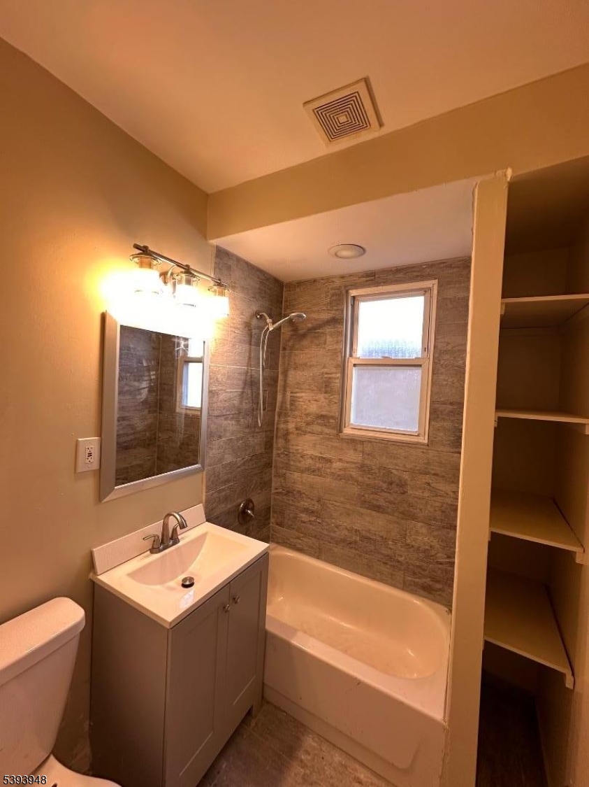 25 Union Place, Unit 1L Irvington, NJ 07111 - Photo 11 of 12 a bathroom with a sink a toilet and bathtub