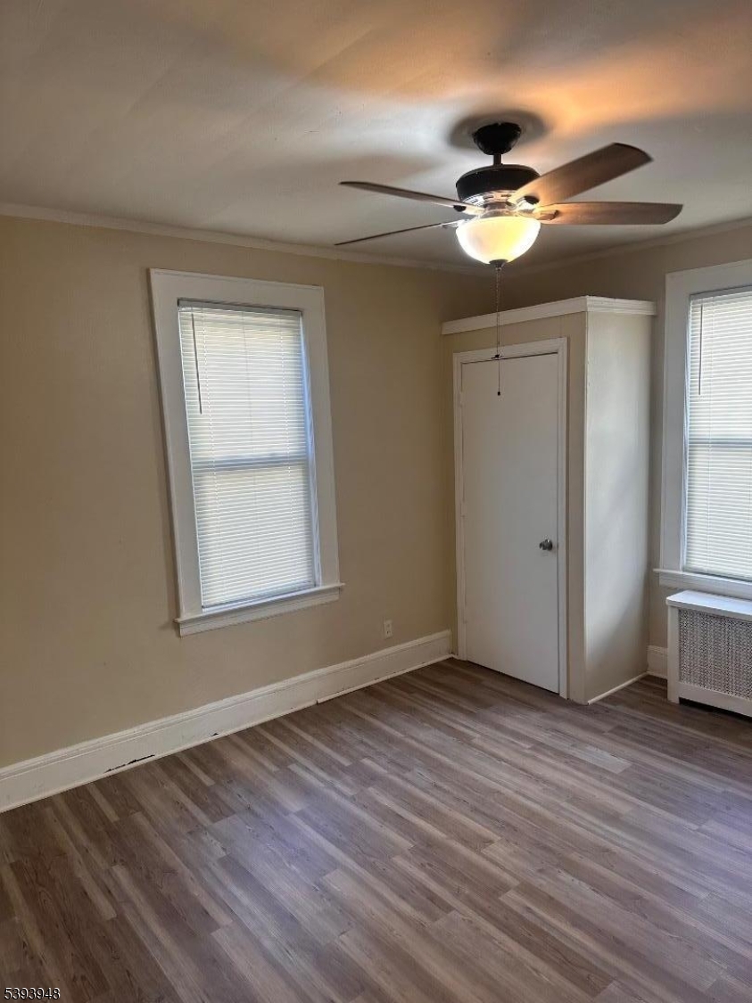 25 Union Place, Unit 1L Irvington, NJ 07111 - Photo 4 of 12 a view of an empty room with wooden floor and a window