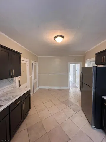 a kitchen with a refrigerator and a sink