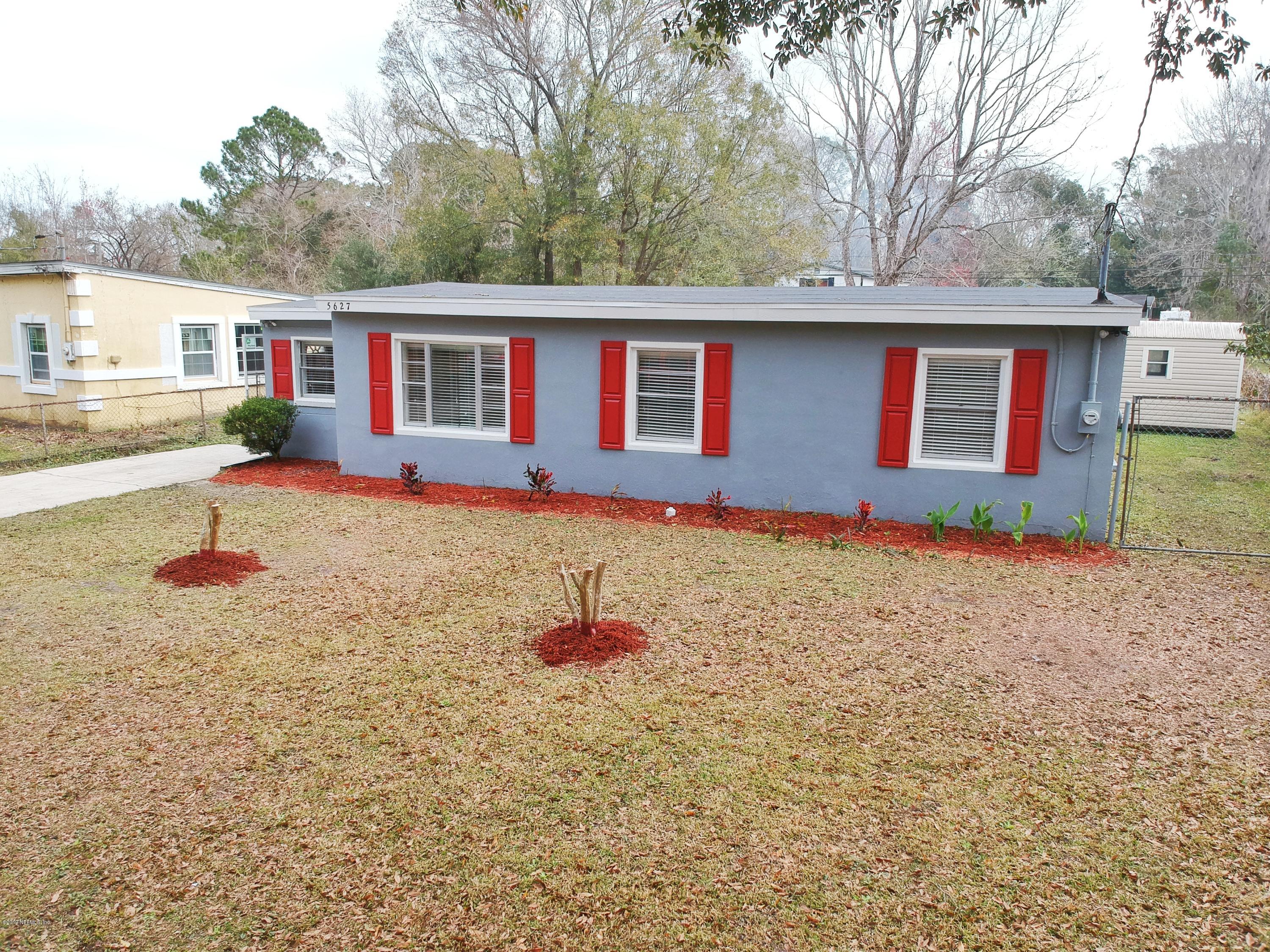 5627 Verbena Road Jacksonville, FL 32209 - Photo 3 of 23 a front view of house with yard and trees in the background