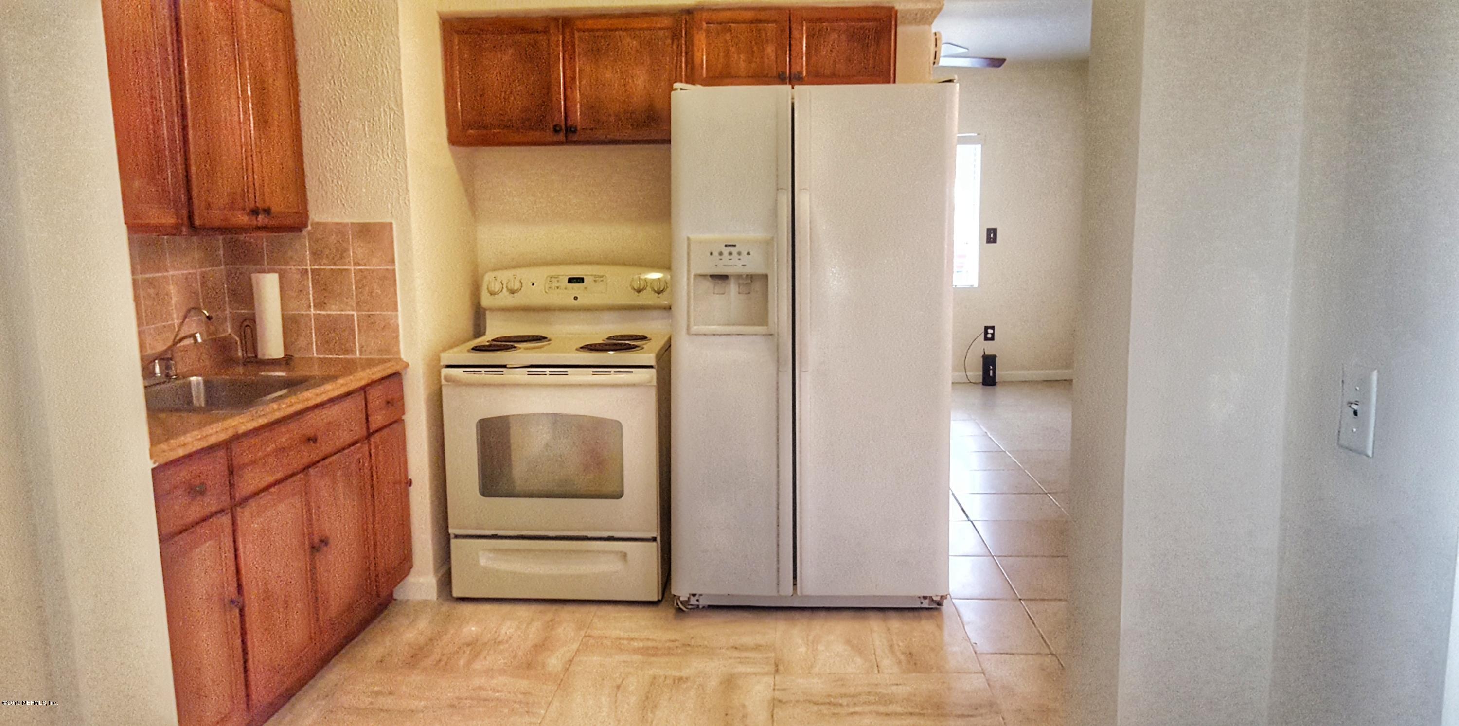 5627 Verbena Road Jacksonville, FL 32209 - Photo 8 of 23 a kitchen with a stove top oven and refrigerator