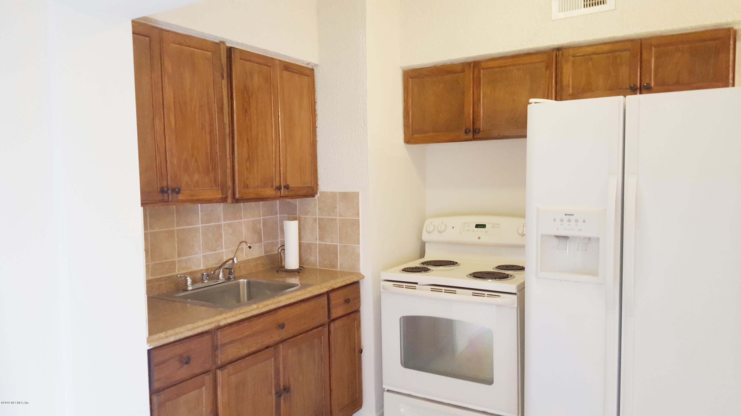 5627 Verbena Road Jacksonville, FL 32209 - Photo 10 of 23 a kitchen with a sink a stove and refrigerator