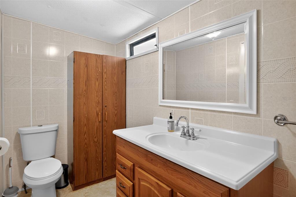 17536 Brinkerhoff Lane Okeechobee, FL 34974 - Photo 15 of 17 a bathroom with a sink a toilet and a mirror