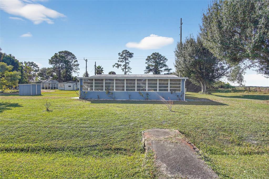 17536 Brinkerhoff Lane Okeechobee, FL 34974 - Photo 4 of 17 a view of a swimming pool with a garden