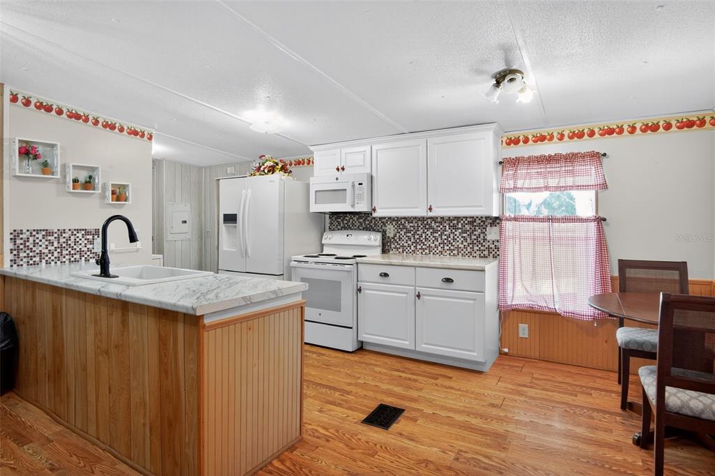 17536 Brinkerhoff Lane Okeechobee, FL 34974 - Photo 8 of 17 a kitchen with white cabinets and sink