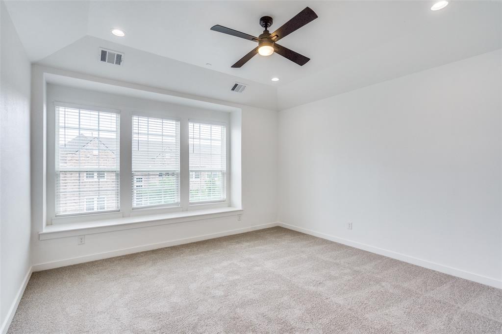 7207 Switchgrass Road Frisco, TX 75033 - Photo 23 of 26 an empty room with a window and a fan