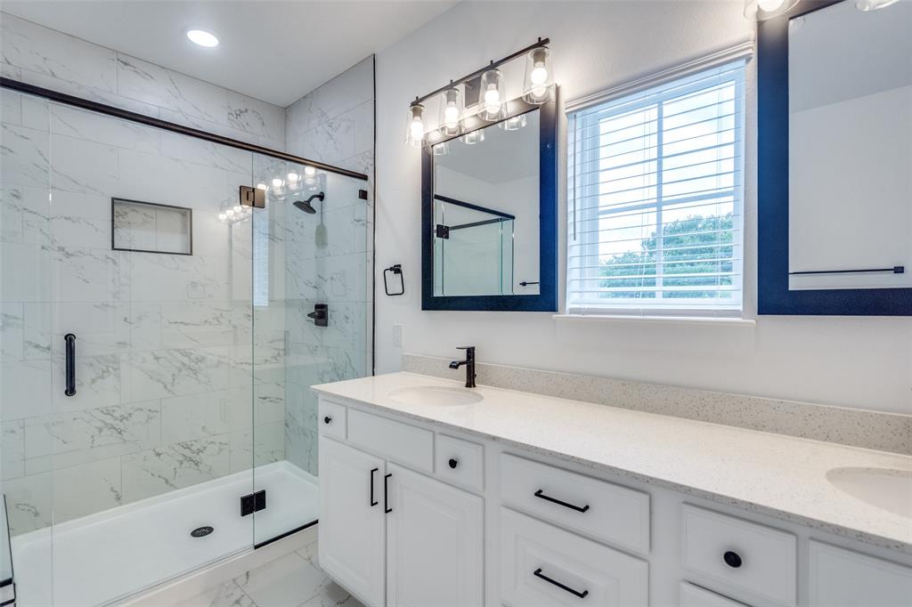7207 Switchgrass Road Frisco, TX 75033 - Photo 25 of 26 a bathroom with a sink tub shower and a mirror