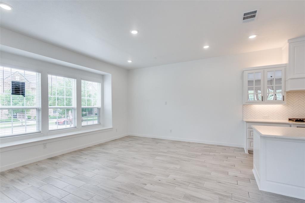 7207 Switchgrass Road Frisco, TX 75033 - Photo 6 of 26 wooden floor in an empty room with a window