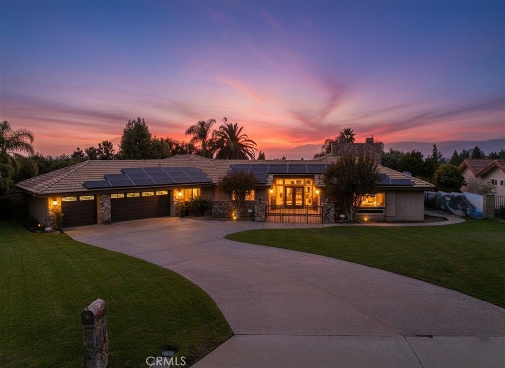 1249 Coronet Drive Riverside, CA 92506 - Photo 1 of 57 a front view of a house with a garden and yard
