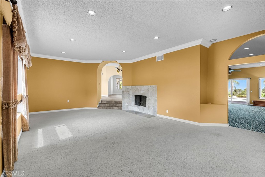 1249 Coronet Drive Riverside, CA 92506 - Photo 14 of 57 a view of an empty room with a fireplace