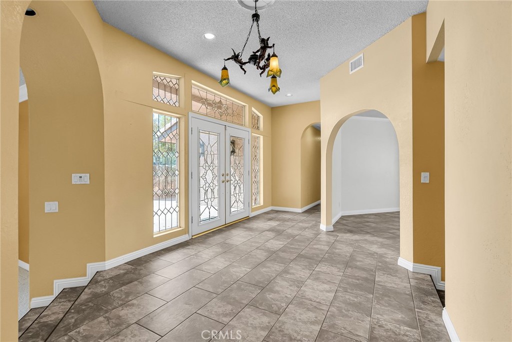 1249 Coronet Drive Riverside, CA 92506 - Photo 19 of 57 a view of an entryway with a chandelier