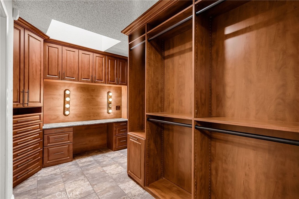 1249 Coronet Drive Riverside, CA 92506 - Photo 24 of 57 a kitchen with kitchen island a counter top space and cabinets