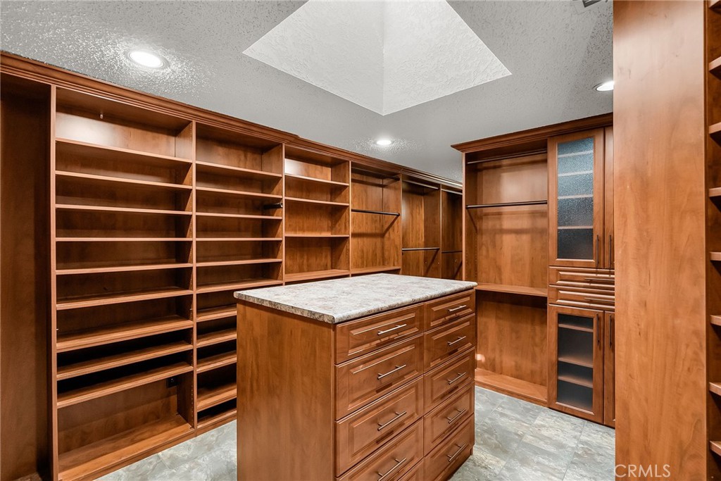 1249 Coronet Drive Riverside, CA 92506 - Photo 25 of 57 a kitchen with a cabinets and a stove top oven
