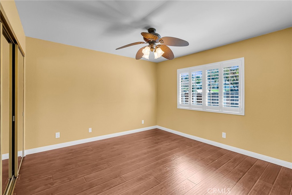 1249 Coronet Drive Riverside, CA 92506 - Photo 30 of 57 a view of an empty room with wooden floor and a window
