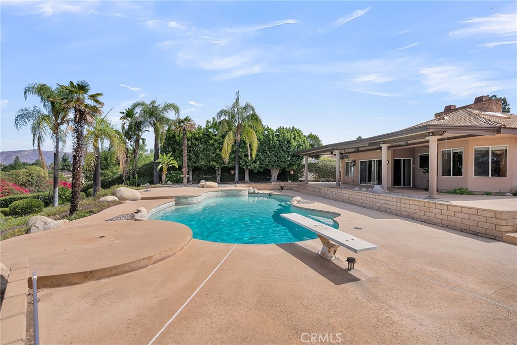 1249 Coronet Drive Riverside, CA 92506 - Photo 42 of 57 a swimming pool with outdoor seating and yard