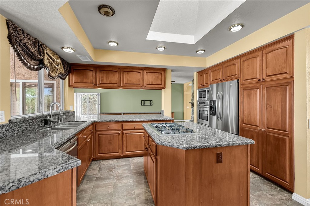 1249 Coronet Drive Riverside, CA 92506 - Photo 10 of 57 a kitchen with stainless steel appliances granite countertop a sink stove and refrigerator