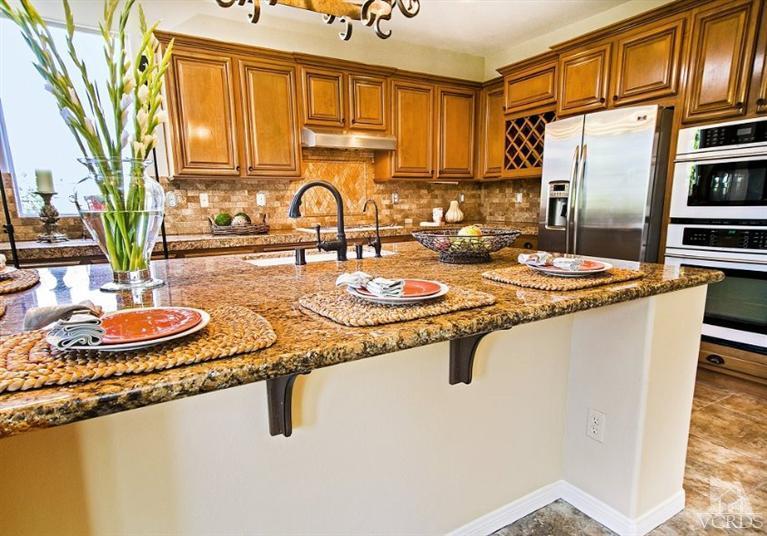 14303 Peach Hill Road Moorpark, CA 93021 - Photo 12 of 41 a kitchen with sink refrigerator and cabinets