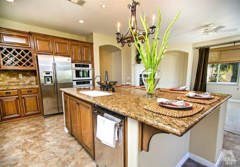 14303 Peach Hill Road Moorpark, CA 93021 - Photo 14 of 41 a kitchen with stainless steel appliances granite countertop a sink and a refrigerator