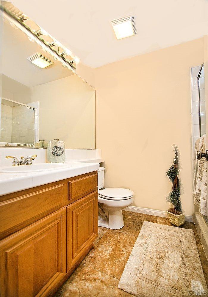 14303 Peach Hill Road Moorpark, CA 93021 - Photo 20 of 41 a bathroom with a sink a toilet and mirror