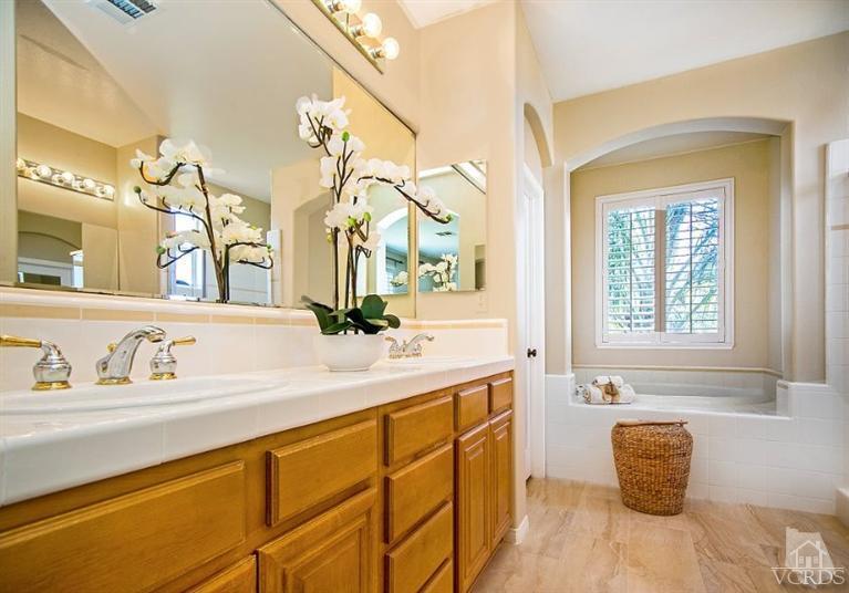 14303 Peach Hill Road Moorpark, CA 93021 - Photo 26 of 41 a bathroom with a sink a toilet and a mirror