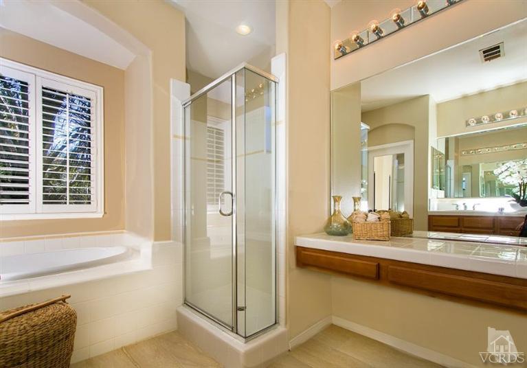 14303 Peach Hill Road Moorpark, CA 93021 - Photo 27 of 41 a bathroom with a tub sink and mirror