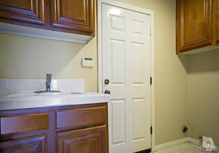 14303 Peach Hill Road Moorpark, CA 93021 - Photo 33 of 41 a bathroom with a sink and a mirror