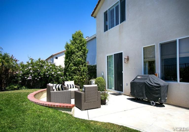 14303 Peach Hill Road Moorpark, CA 93021 - Photo 36 of 41 a view of a chair and tables in the backyard