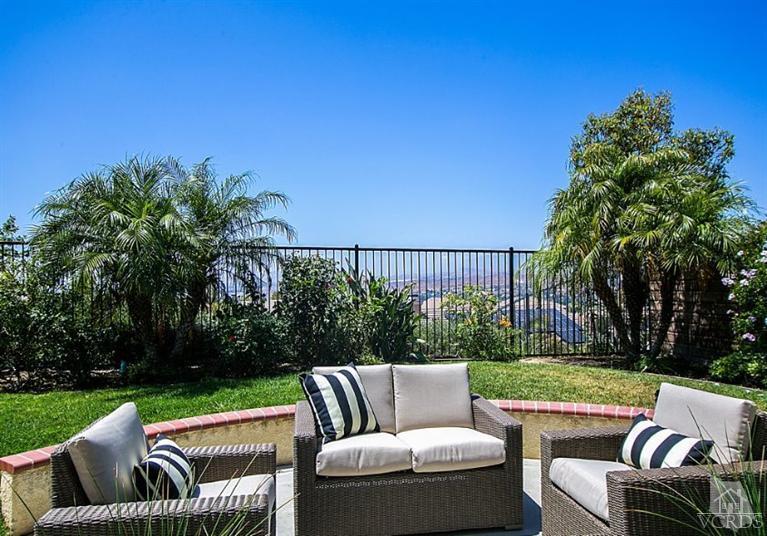 14303 Peach Hill Road Moorpark, CA 93021 - Photo 40 of 41 a view of a patio with couches and a table and chairs with wooden fence