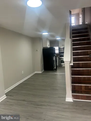 a view of a room with wooden floor