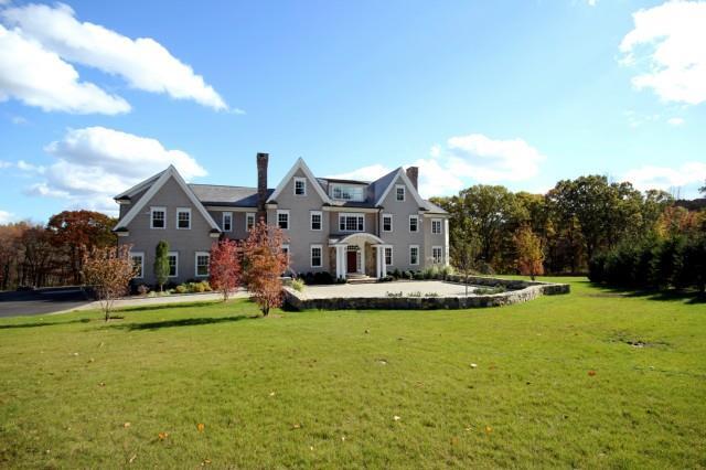 a aerial view of a house with a big yard and large trees