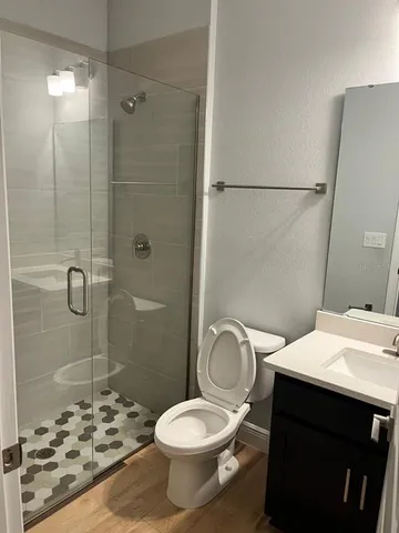 a bathroom with a sink toilet and shower