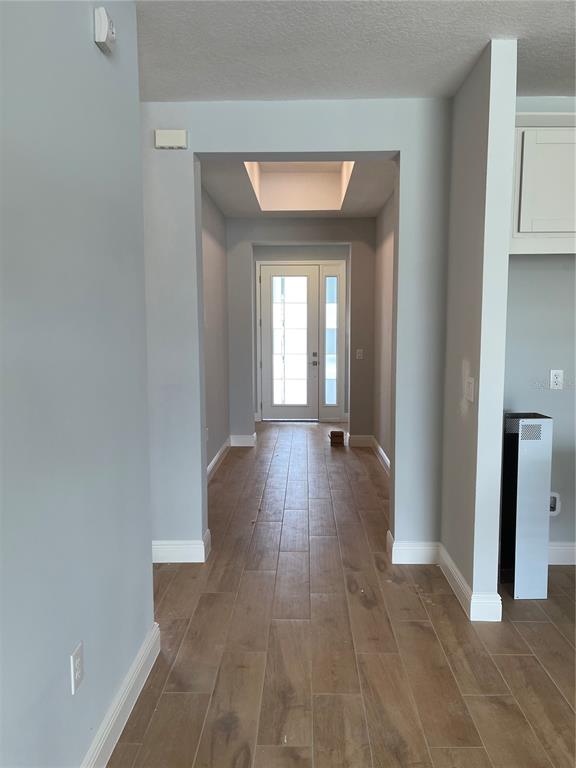 19284 Allium Place Orlando, FL 32827 - Photo 4 of 15 a view of a hallway with wooden floor and closet