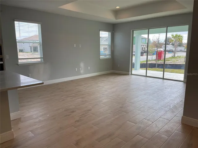 an empty room with sliding door and mountain view