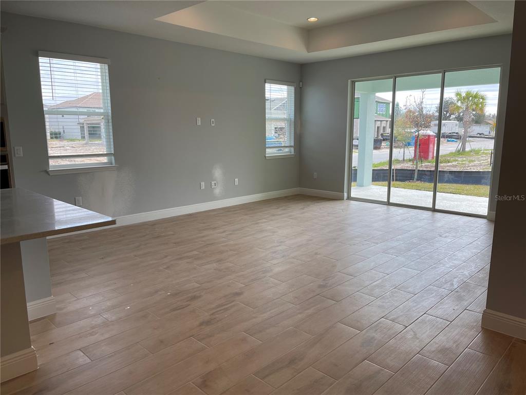 19284 Allium Place Orlando, FL 32827 - Photo 5 of 15 an empty room with sliding door and mountain view