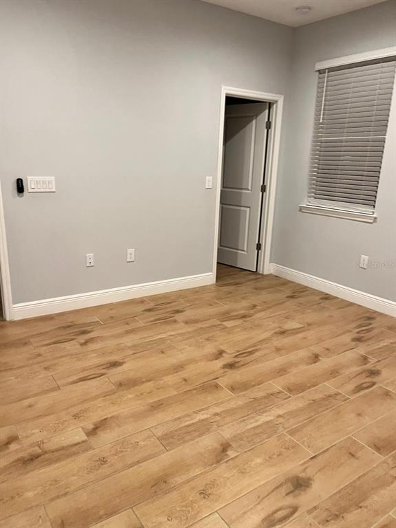 19284 Allium Place Orlando, FL 32827 - Photo 8 of 15 an empty room with wooden floor and windows