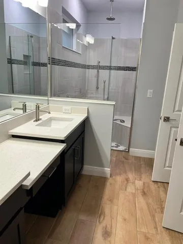 a bathroom with a sink a mirror and a bath tub
