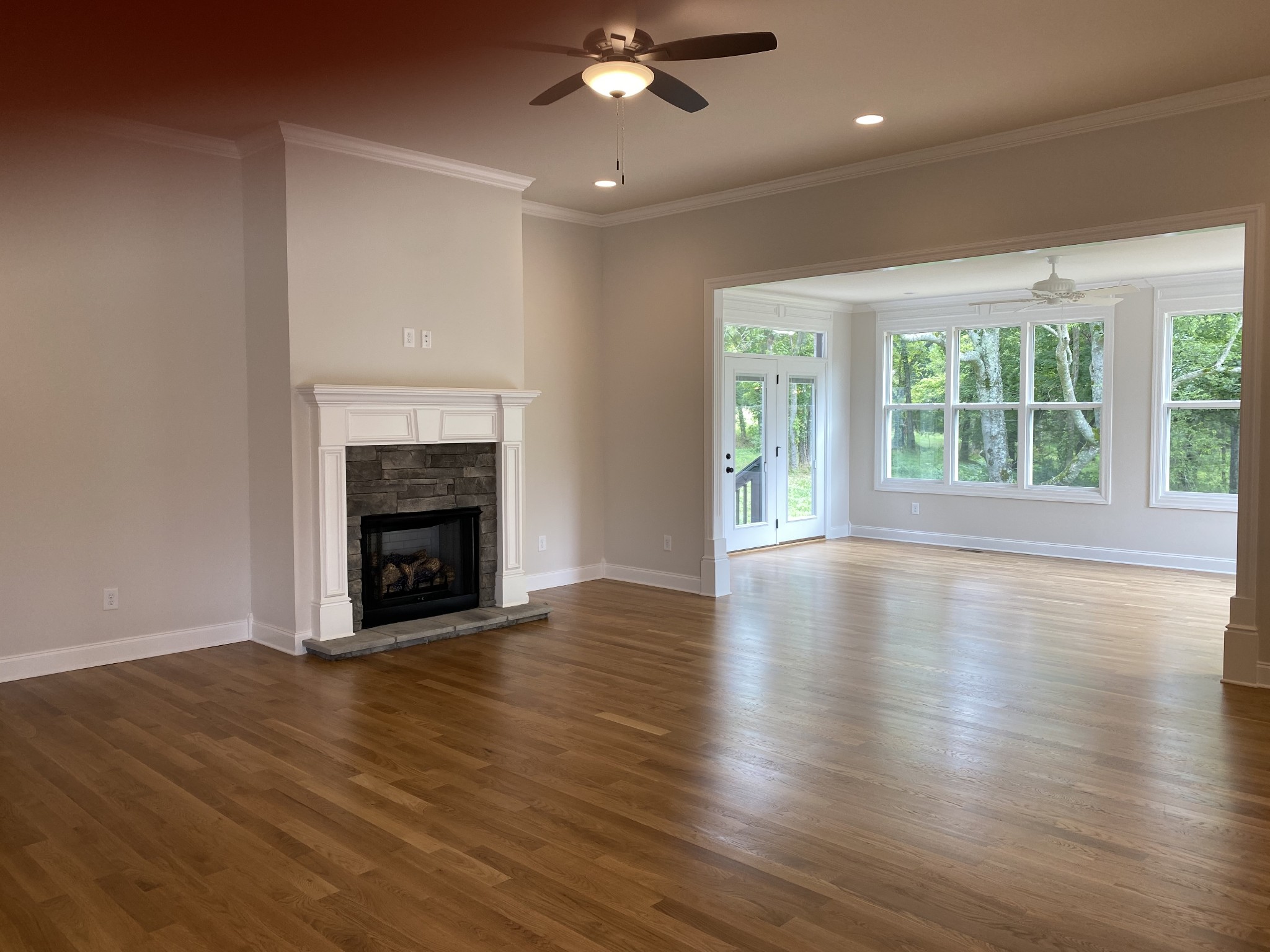 1074 Hideaway Road Columbia, TN 38401 - Photo 3 of 10 an empty room with wooden floor fireplace and windows