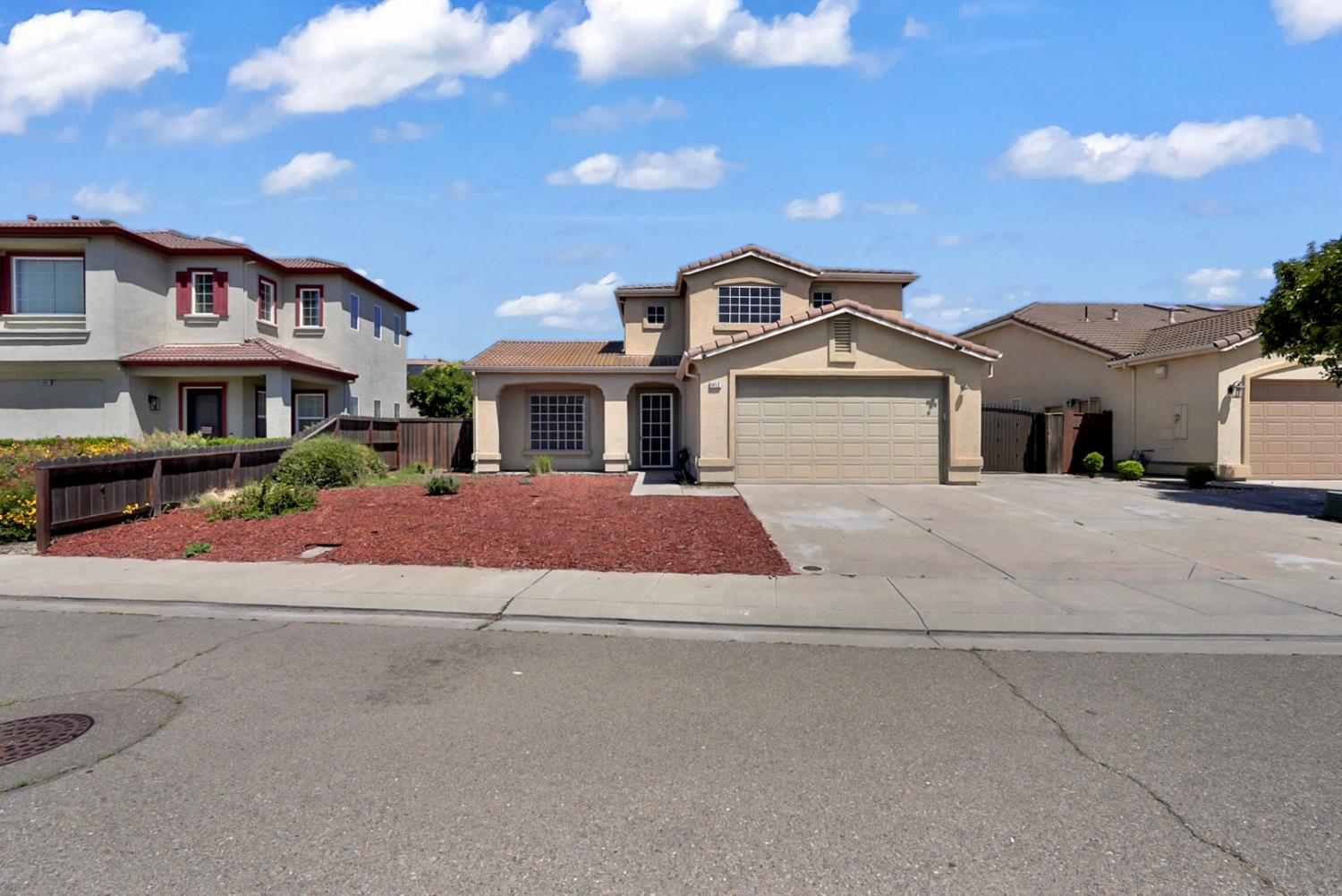 1412 Red Ribbons Lane Manteca, CA 95337 - Photo 1 of 32 a front view of a house with a yard