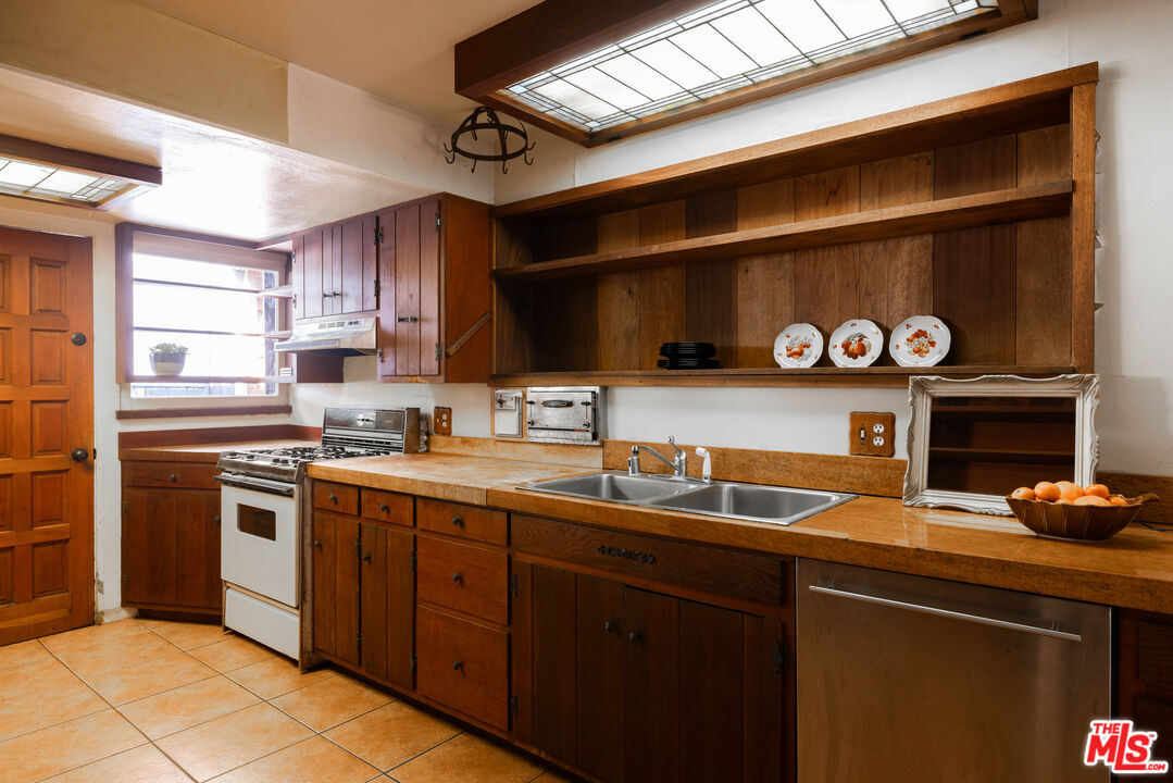 1748 Laurel Canyon Boulevard Los Angeles, CA 90046 - Photo 13 of 24 a kitchen with a sink cabinets and appliances